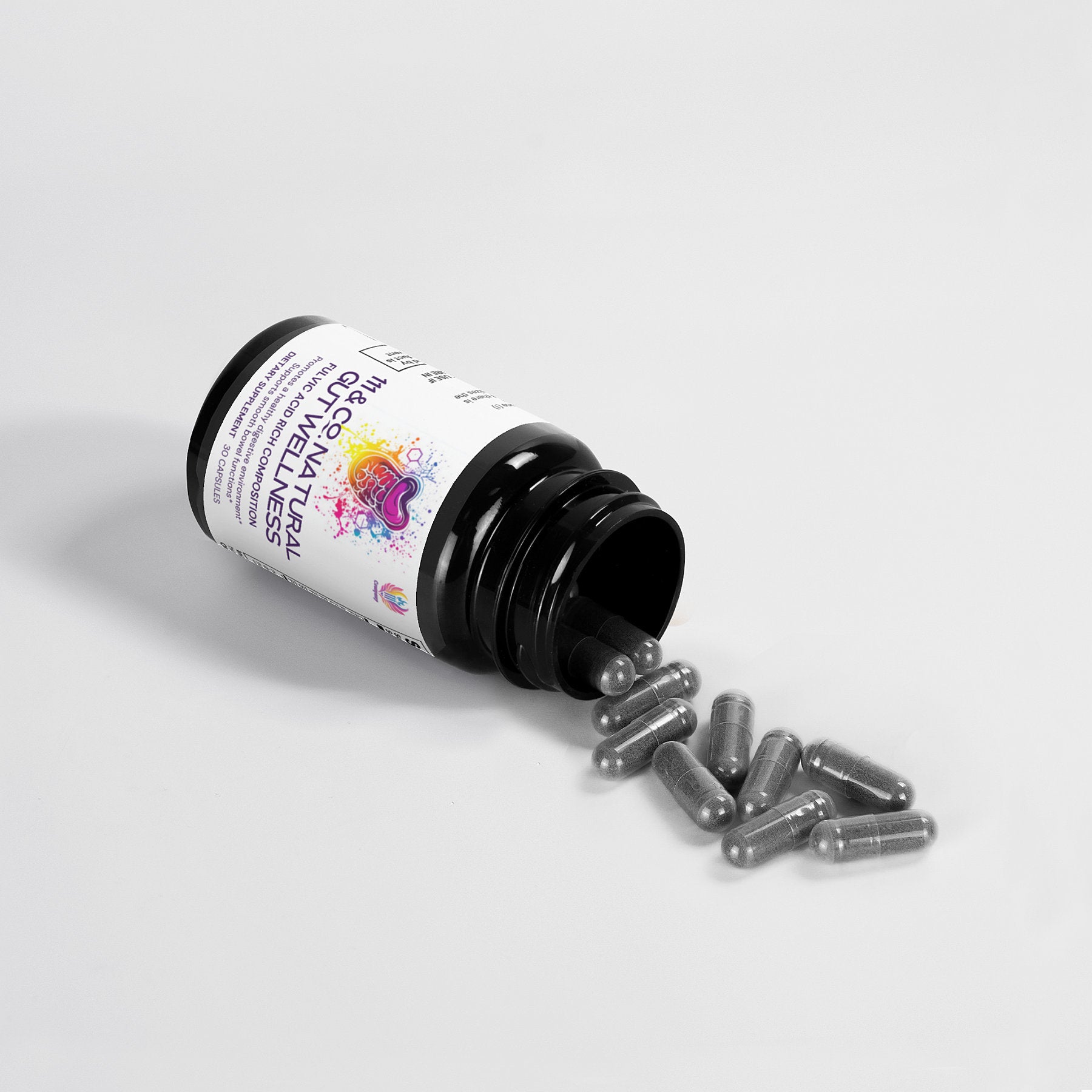A dark bottle labeled 111 & COMPANY NATURAL GUT WELLNESS CAPSULES by 111 & Company is tipped over on a white surface, spilling gray capsules. The label features colorful graphics and text, highlighted under bright lighting to showcase the capsules and contents.