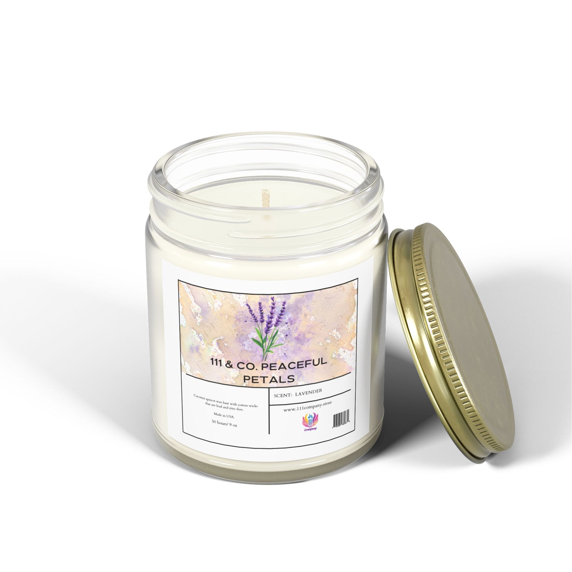 A white candle in a clear glass jar with a gold lid lies beside it, labeled 111 & Company Peaceful Petals with lavender illustrations, made from eco-friendly coconut apricot wax. This 9oz candle by 111 & Company is on a white surface, casting a soft shadow and inviting relaxation.
