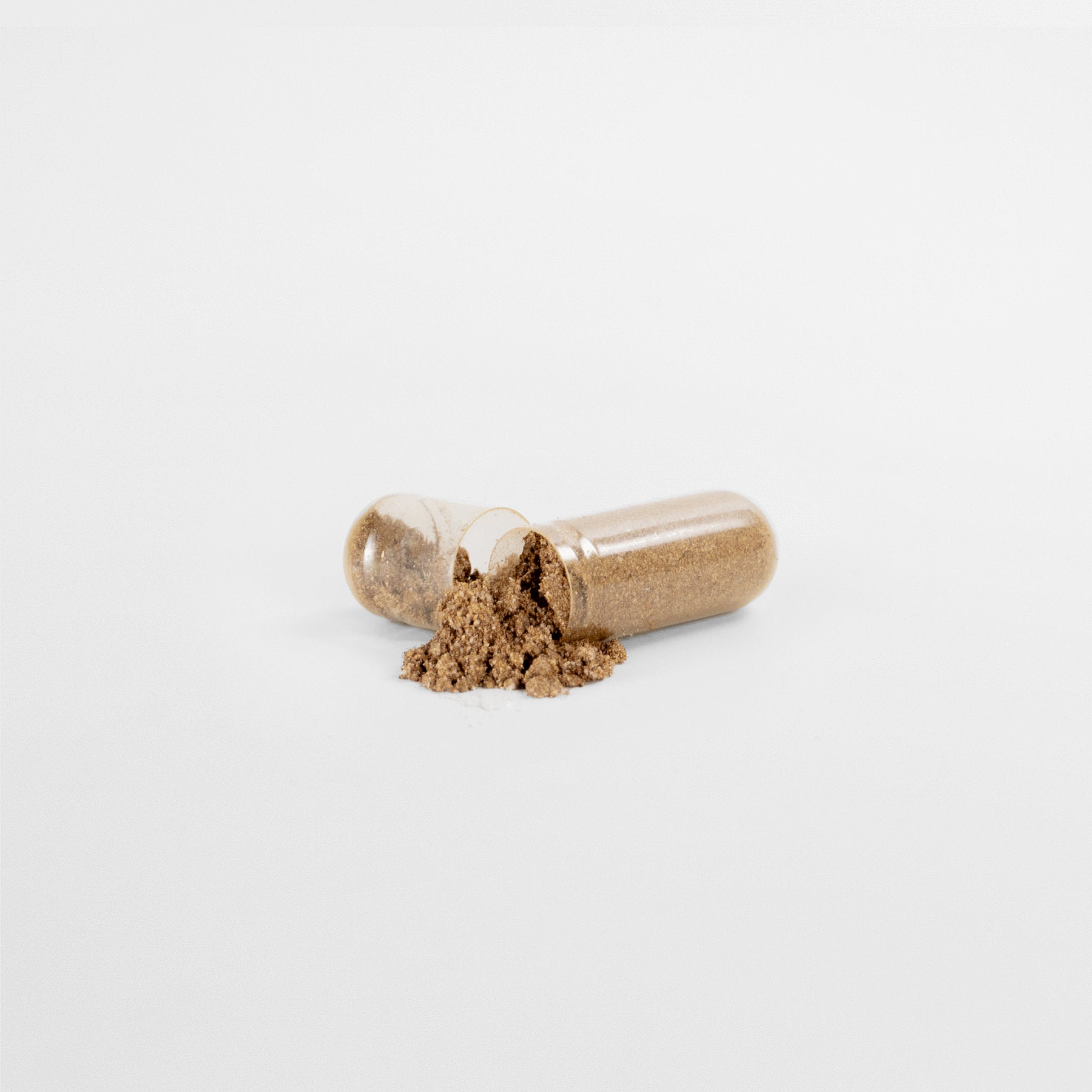 On a white background, an open transparent capsule of 111 & COMPANY PROSTATE SUPPORT by 111 & Company spills brown powder from one half. The horizontal halves exhibit the powdery substance inside, highlighting natural ingredients for mens wellness.