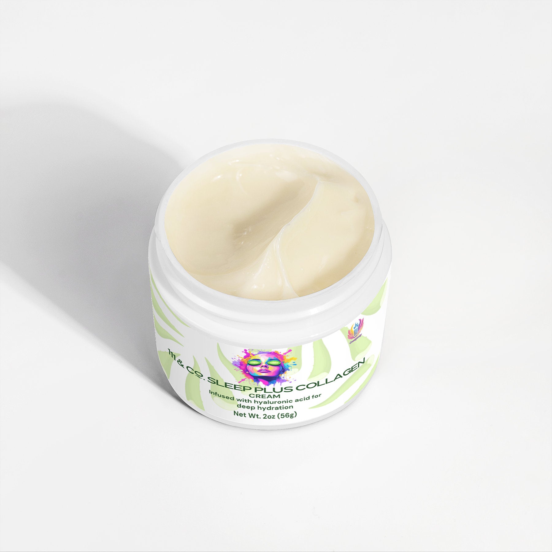 An open jar of hydrating collagen cream with a light beige color and smooth texture, labeled 111 & COMPANY SLEEP PLUS COLLAGEN CREAM. The white label features abstract green leaves, and the packaging includes colorful artwork of a face by 111 & Company—ideal for your skincare routine.