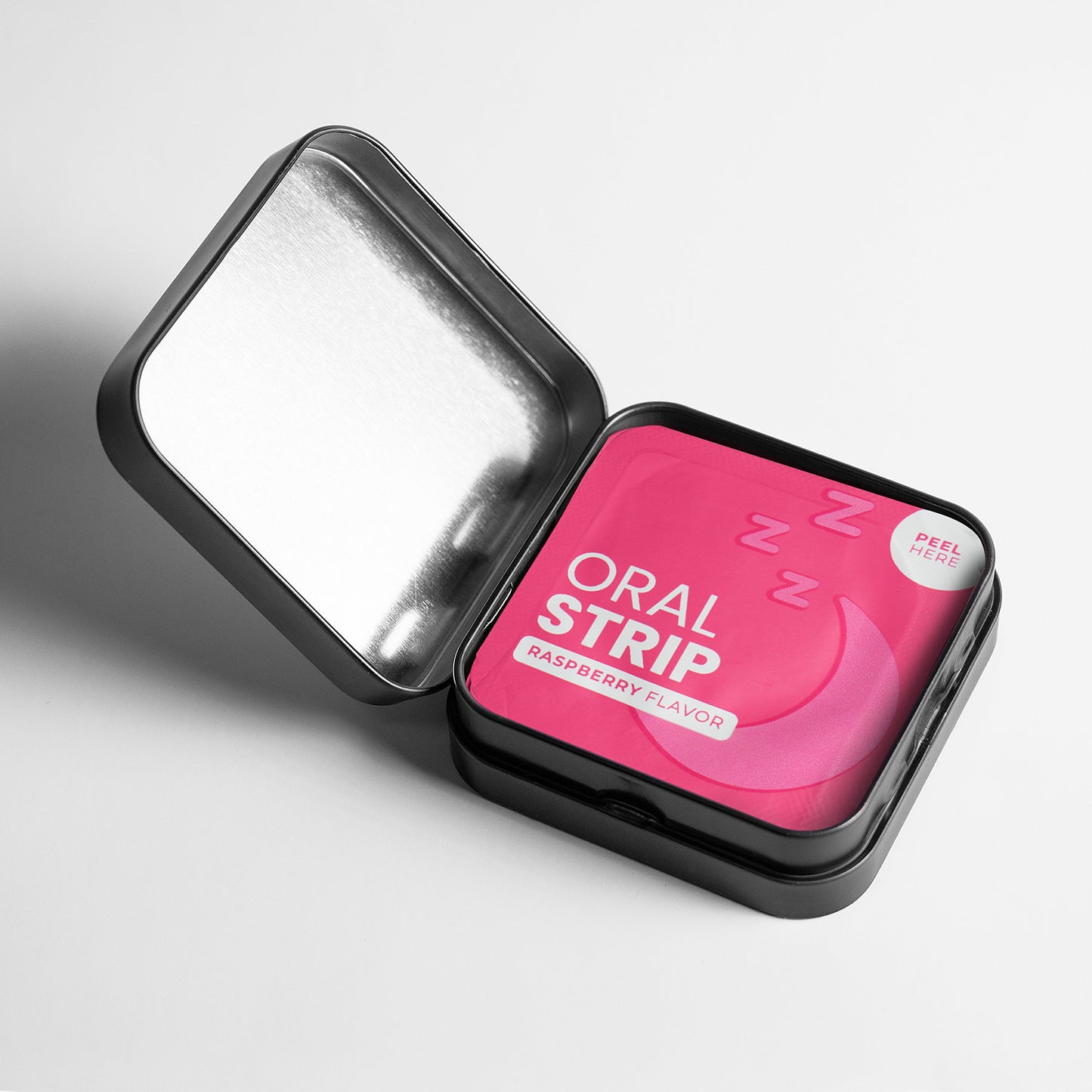 A small, open black tin marked 111 & COMPANY SLEEP STRIPS TO GO by 111 & Company showcases a pink Oral Strip Raspberry Flavor packet with a crescent moon and zzz. Designed as a non-addictive sleep aid, it features a Peel Here tab. The lid glistens on the white background.