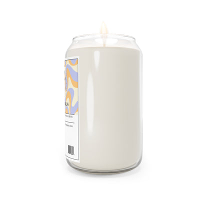 The 111 & Company Vanilla Vibes candle, with a vanilla bean scent, is housed in a clear glass jar shaped like a soda can, featuring a white label with colorful wavy blue, orange, and yellow patterns. It rests against a plain white background.
