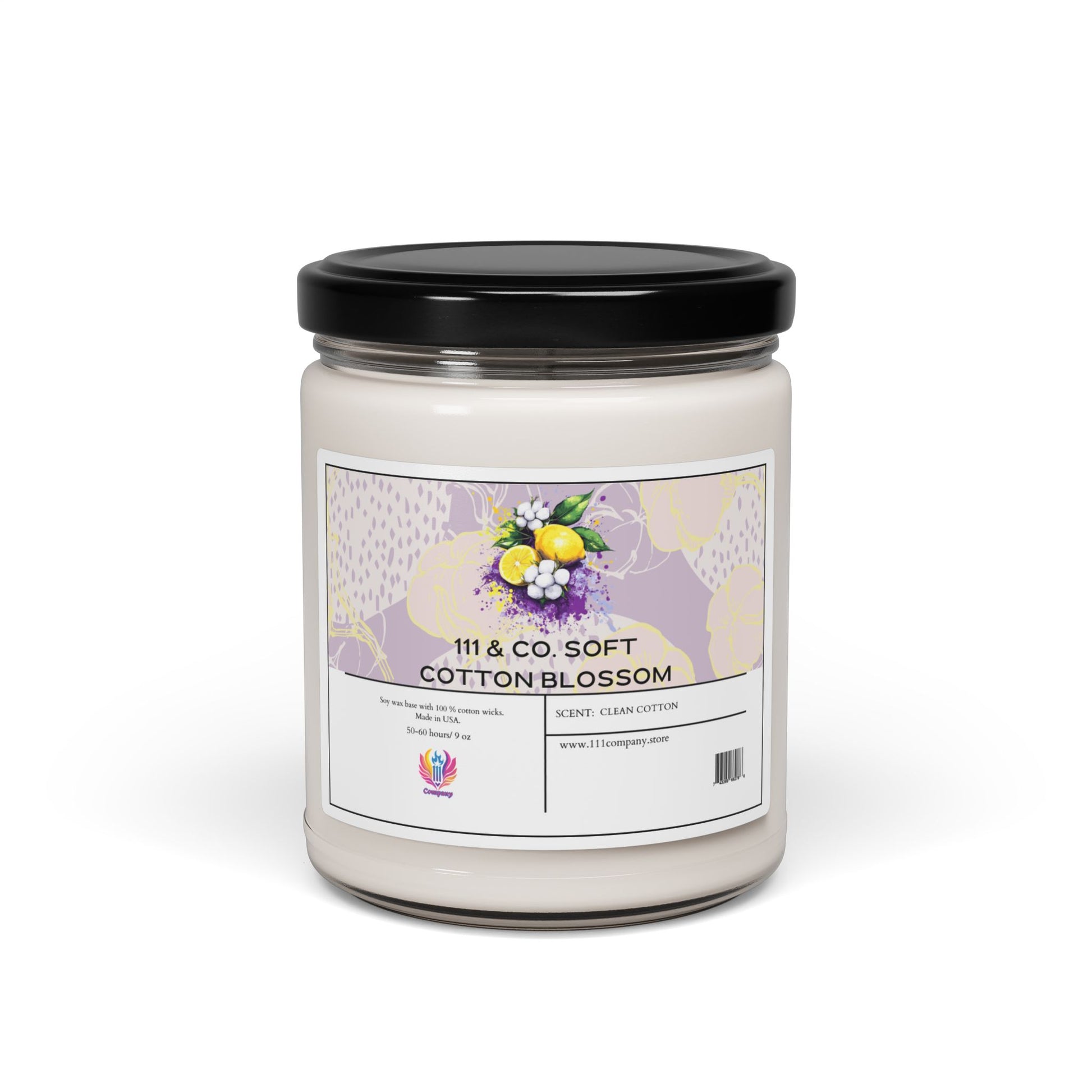 The 111 & Company Soft Cotton Blossom candle by Printify is a soy wax 9oz eco-friendly glass jar with a black lid. It features a floral label with lemons and purple flowers, labeled Scent: Clean Cotton for a fresh ambiance. Discover more at www.111company.com.