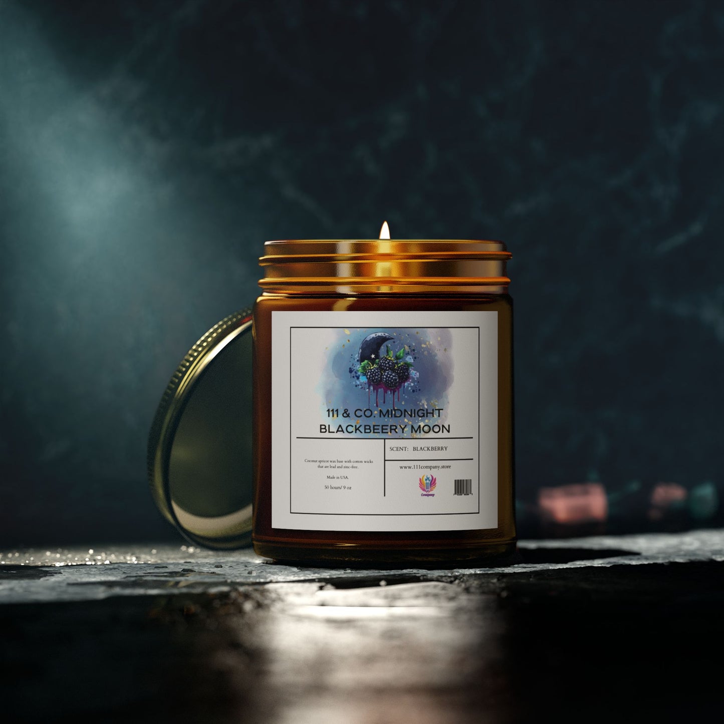 The 9oz Printify 111 & Company Midnight Blackberry Moon Scented Candle in an amber jar casts a warm glow and fruity scent. The moon and tree watercolor label complements its gold lid on a textured dark surface, with blurred lights adding ambiance.