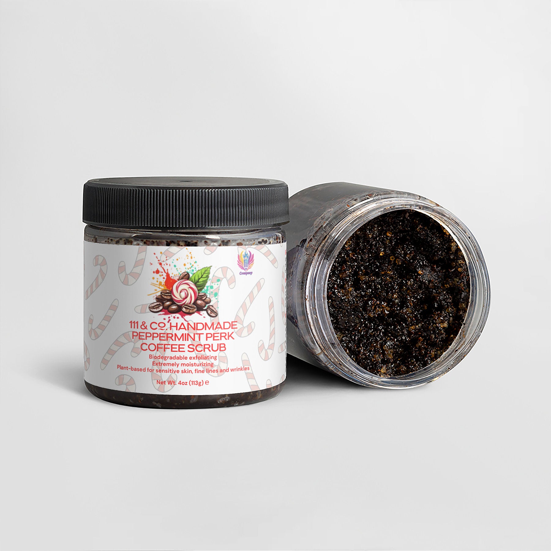 Two containers of 111 & Company Handmade Peppermint Perk Coffee Scrub are displayed: one upright with a floral label, the other open to showcase its exfoliating texture. The simple gray background accentuates the products natural appeal.