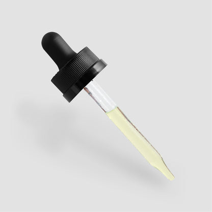 A 111 & COMPANY MOISTURIZING AND STRENGTHENING HAIR OIL dropper from Retro Fitness Supplements features a black rubber top and transparent glass tube with pale yellow liquid, positioned on a light gray background, showcasing its premium ingredients and sleek design that promises intense moisturization.