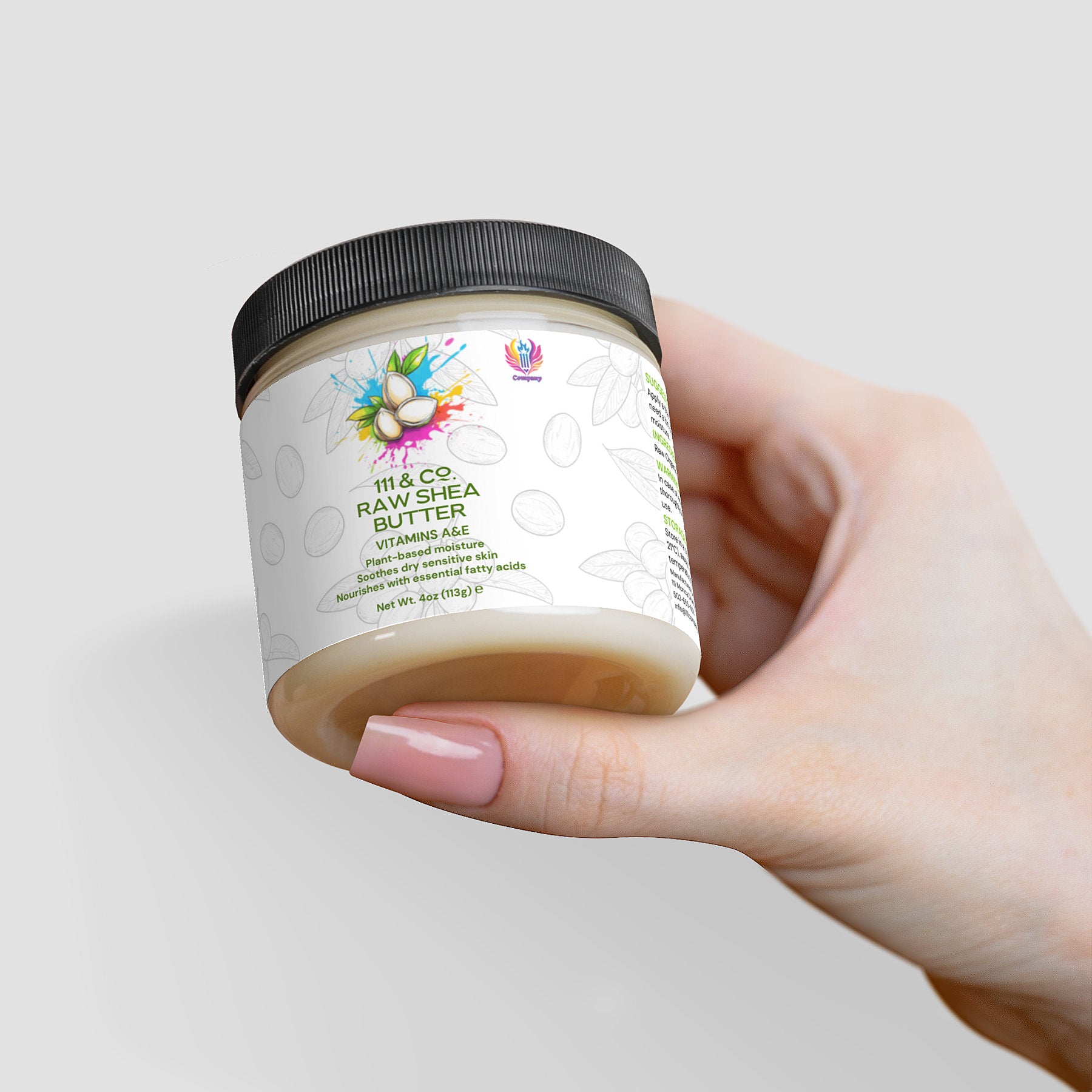 A hand displays a jar of Retro Fitness Supplements 111 & COMPANY RAW SHEA BUTTER, a plant-based moisturizer. The black-lidded jar has a white label with an avocado illustration and colorful splashes, featuring Raw Shea Butter and vitamins A, E on a light gray background.