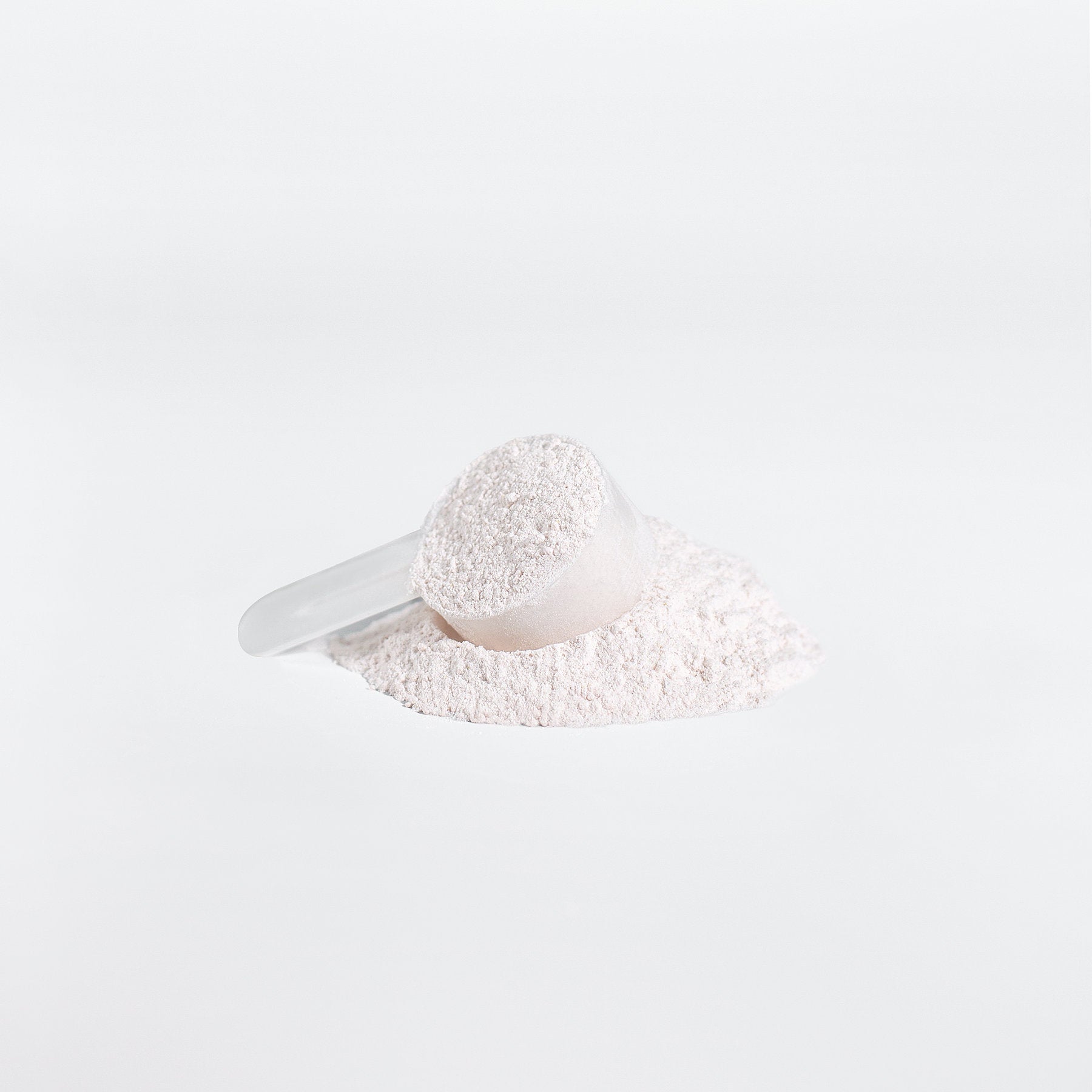 A clear scoop of 111 & COMPANY BCAA POST WORKOUT POWDER (HONEYDEW/WATERMELON) from retro fitness supplements sits on white powder against a pristine backdrop, highlighting amino acids role in muscle recovery. Soft shadows accentuate the minimalist image.