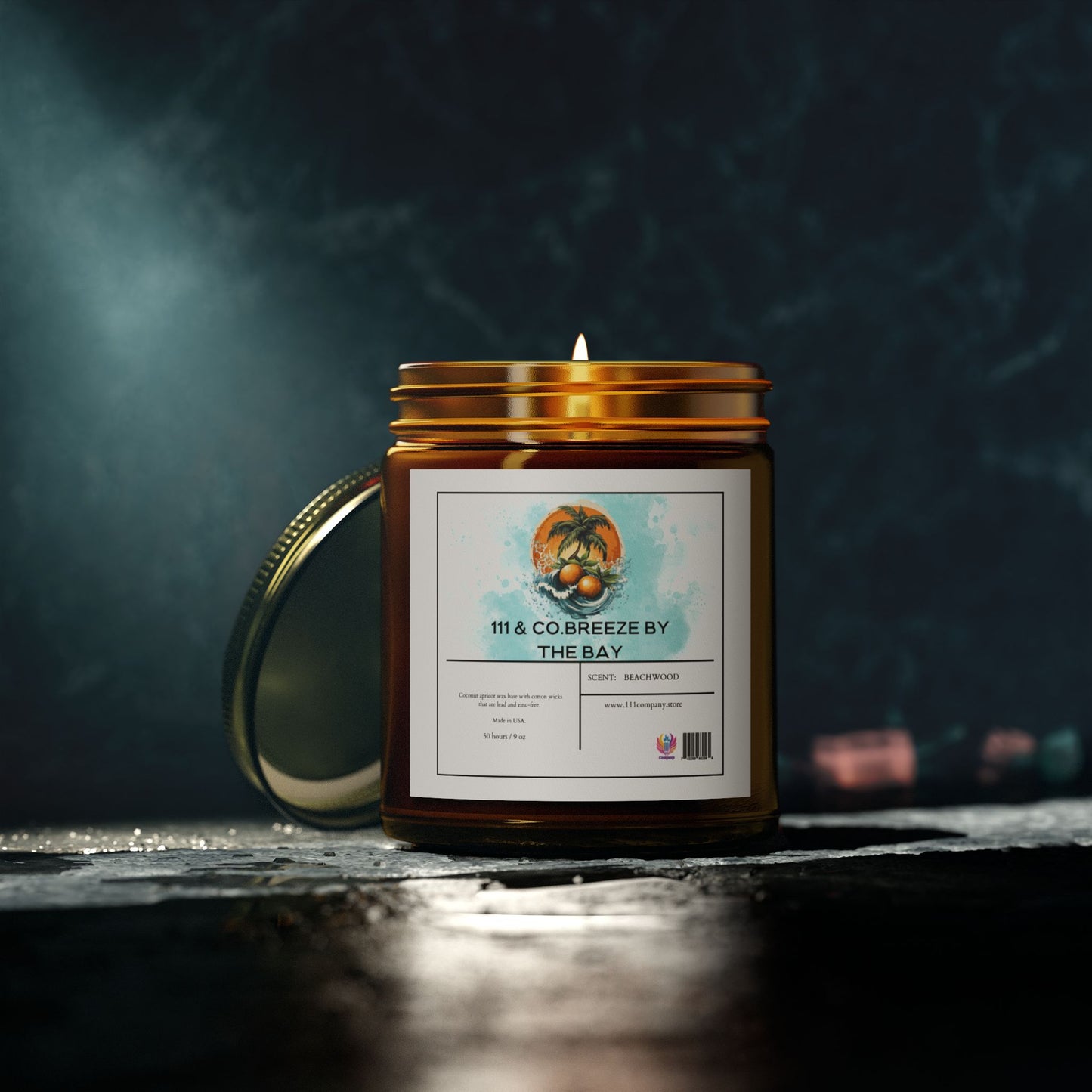 A 111 & COMPANY Breeze by the Bay Beachwood Scented Candle in a brown glass jar rests on a dark stone surface. The label with palm trees and a ship stands out. A gold lid is partially open, enhanced by ambient moody lighting against a blurred background. Product by Printify, 9oz coconut apricot wax.