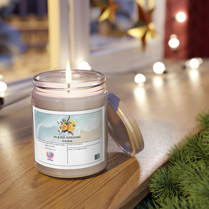 A 111 & Company Oceanic Oasis Sea Breeze Scented Candle by Printify rests on wood, infused with citrus notes. Nearby greenery and a blurred backdrop of festive lights complete the scene. Its lid leans beside the candle, enhancing the cozy atmosphere.