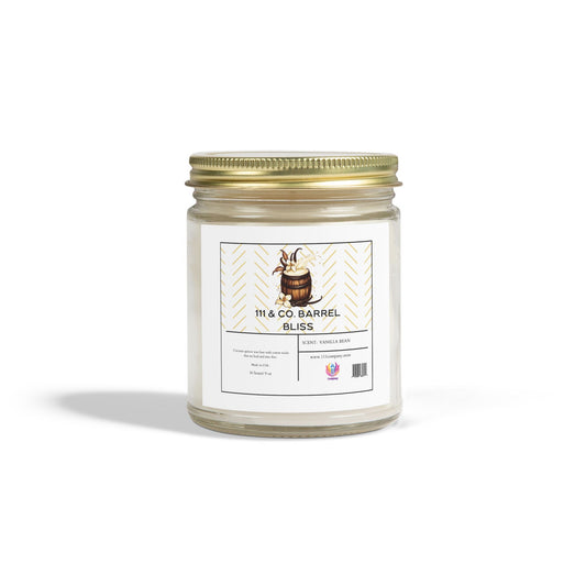 A clear jar candle by Printify features a gold metal lid and a white label with a barrel design, reading 111 & Company Barrel Bliss and Scent: Vanilla Bean. Made from coconut apricot wax, the 9oz candle highlights its bourbon fragrance with barcode and logo below, casting a shadow on white.