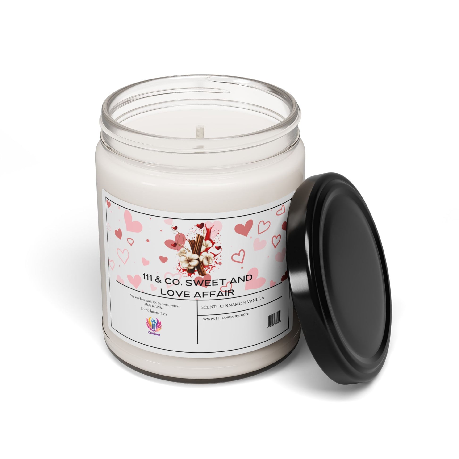 Printifys 111 & Company Sweet and Love Affair Soy Wax Candle (9oz) emits a cinnamon vanilla aroma. Its label, adorned with cream and pink heart designs featuring flowers and cinnamon sticks, sets a cozy mood. The white candle sits beside its black lid on a white surface.